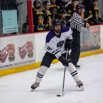 Hockey player skating with puck