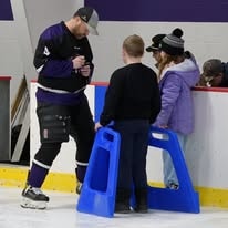 Coach instructing ice hockey players