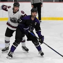 Ice hockey players competing for puck